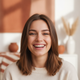 Close-up portrait of a smiling young adult with clear skin, conveying happiness and relief.